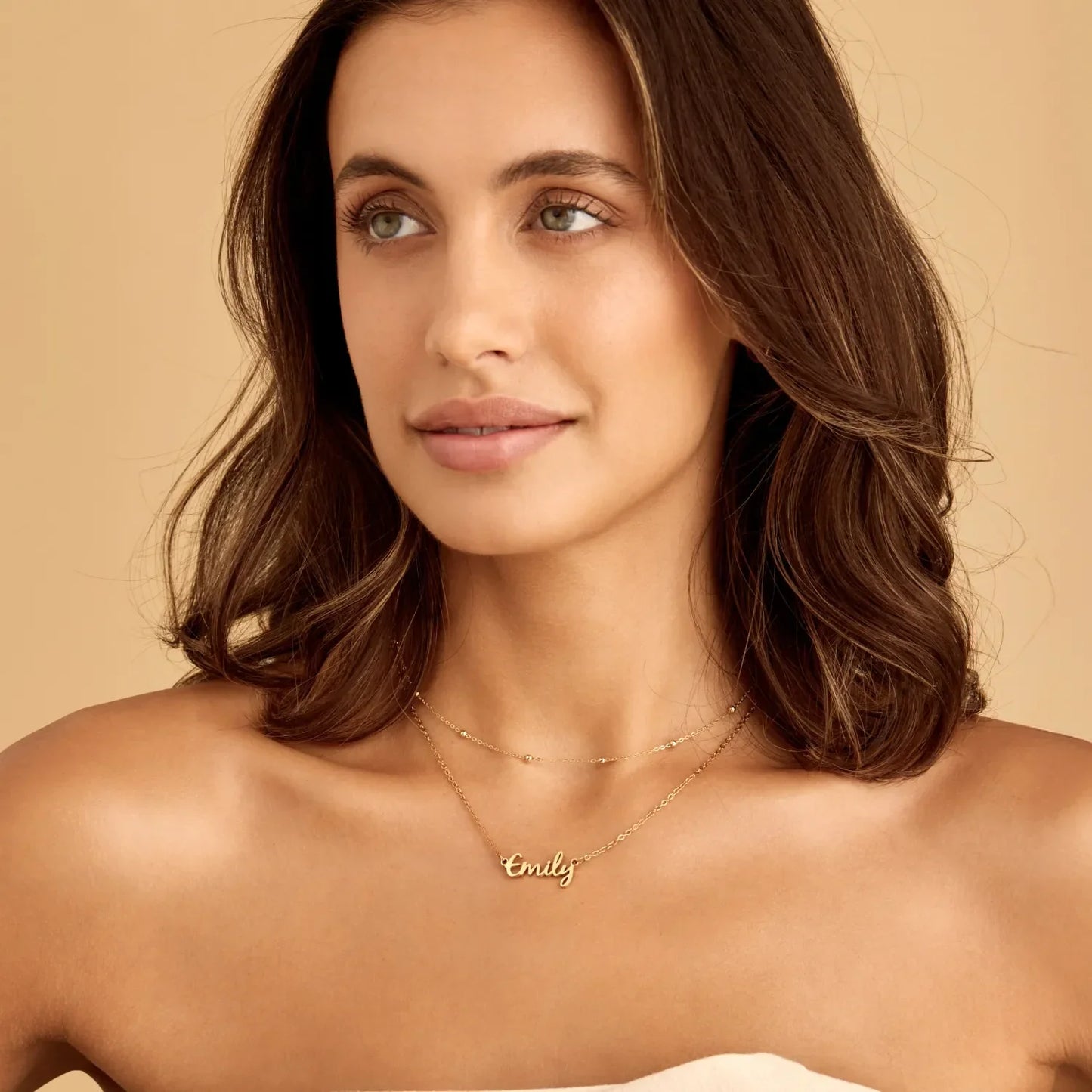 Gold signature name necklace worn on model — Olivia Jewelry